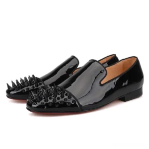 Black patent leather gothic loafers with spike toe cap, three-quarter front view showcasing slip-on design and glossy finish