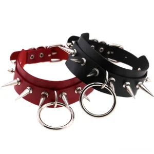 Flat lay overhead view of two gothic spike rivet leather chokers in complementary colors with metal O-rings on white background