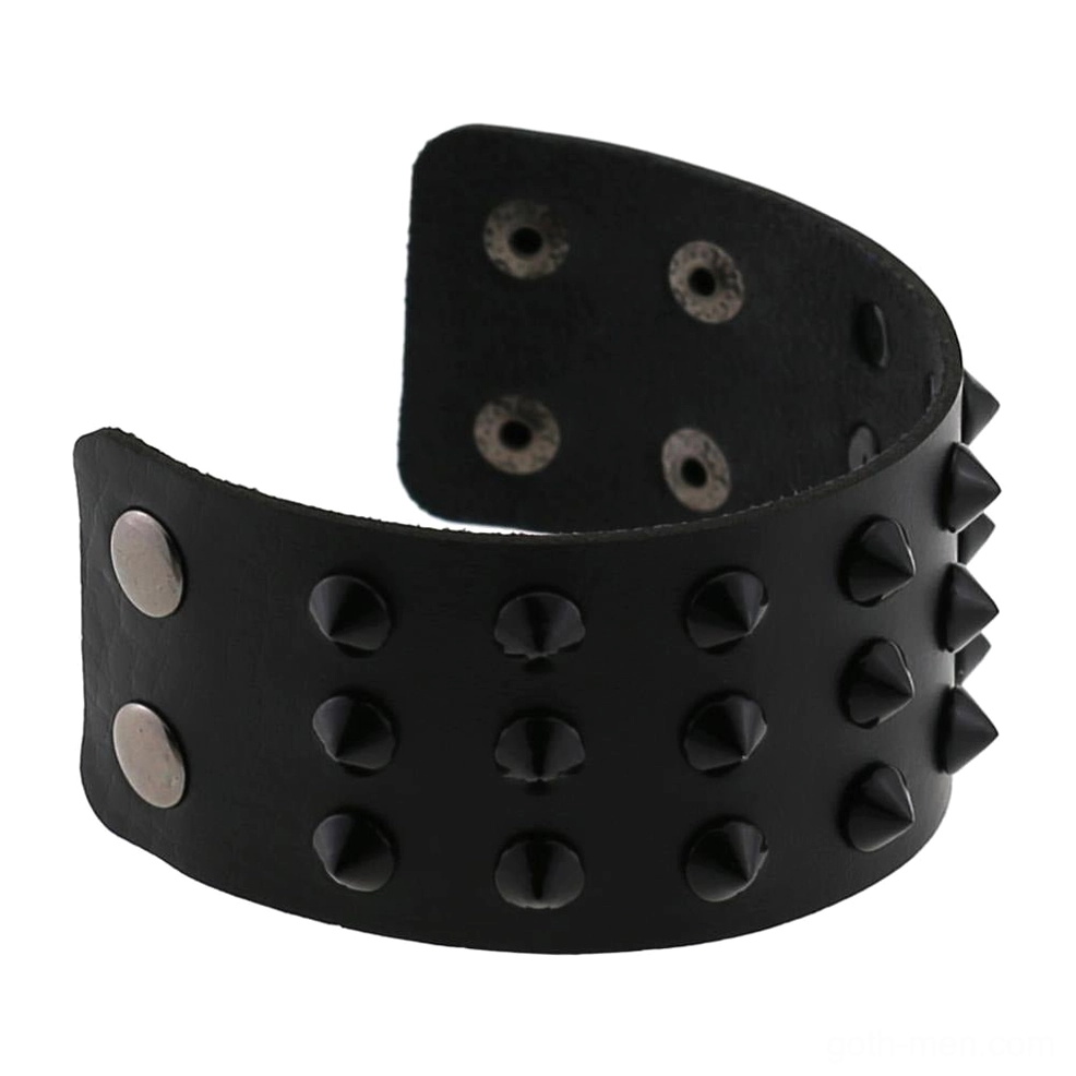 Wide gothic spike bracelet flat lay showing full adjustable strap and metal snap closure mechanism