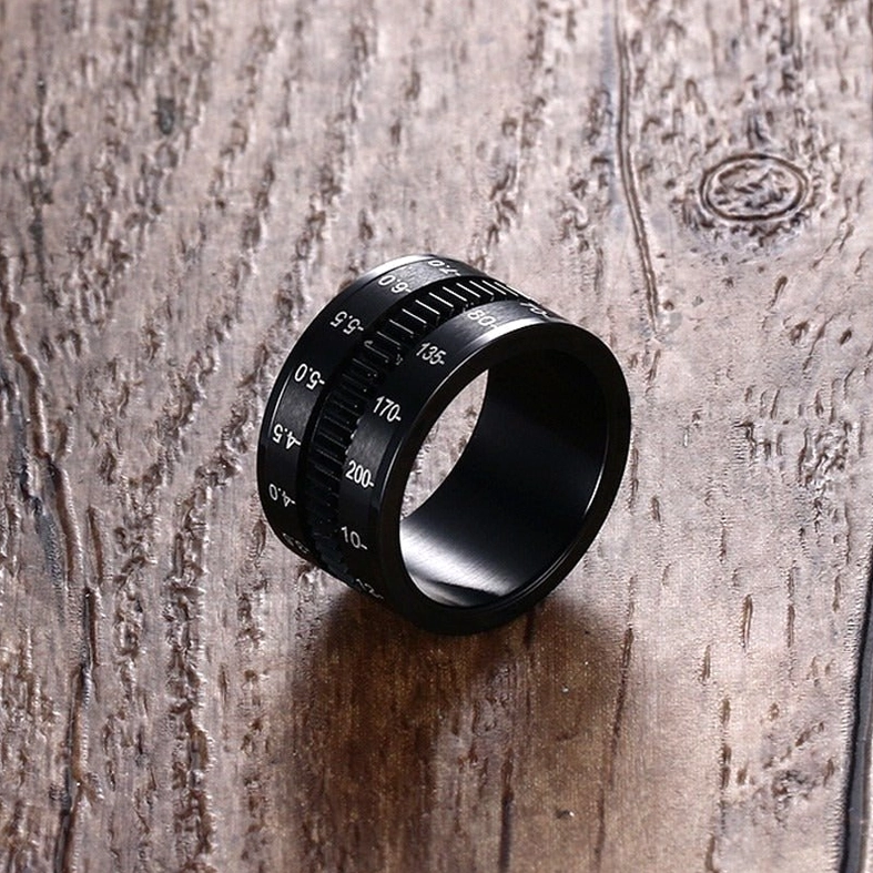 Industrial gothic spinner ring with focal length numerals detailed close-up view