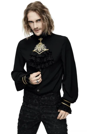 Black gothic men's stand collar shirt with gold embroidered chiffon ruffle chest piece, front view on model with long dark hair