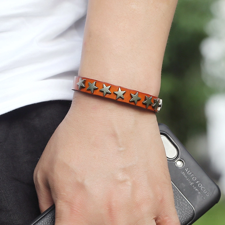 Light brown leather gothic bracelet with silver star studs worn on human wrist, showing natural fit and daily wearability