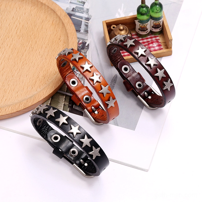 Complete three-piece star leather bracelet collection in black, brown, and camel displayed on vintage wooden tray setting