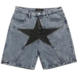 Light blue gothic denim shorts with contrasting black star patchwork design, front flat lay view with studio background
