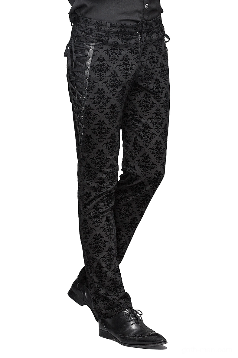 Male model wearing gothic steampunk black slim-fit pants with damask pattern and side lace-up corset details, full side view