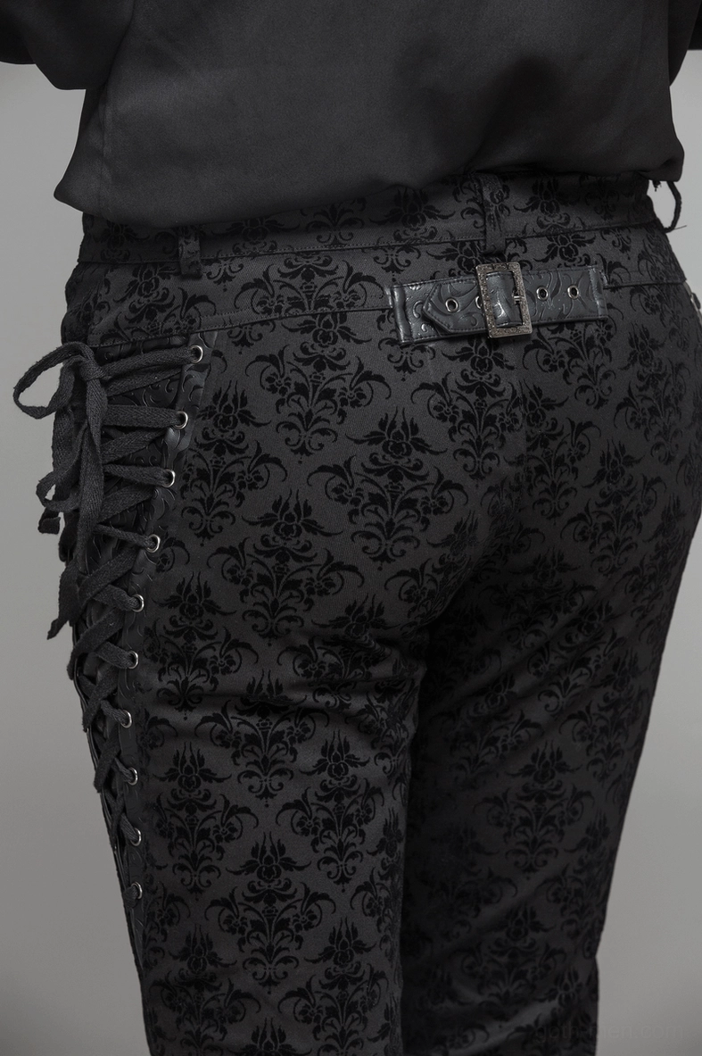 Gothic steampunk slim-fit black pants with all-over damask pattern, corset lace-up sides, and premium construction details