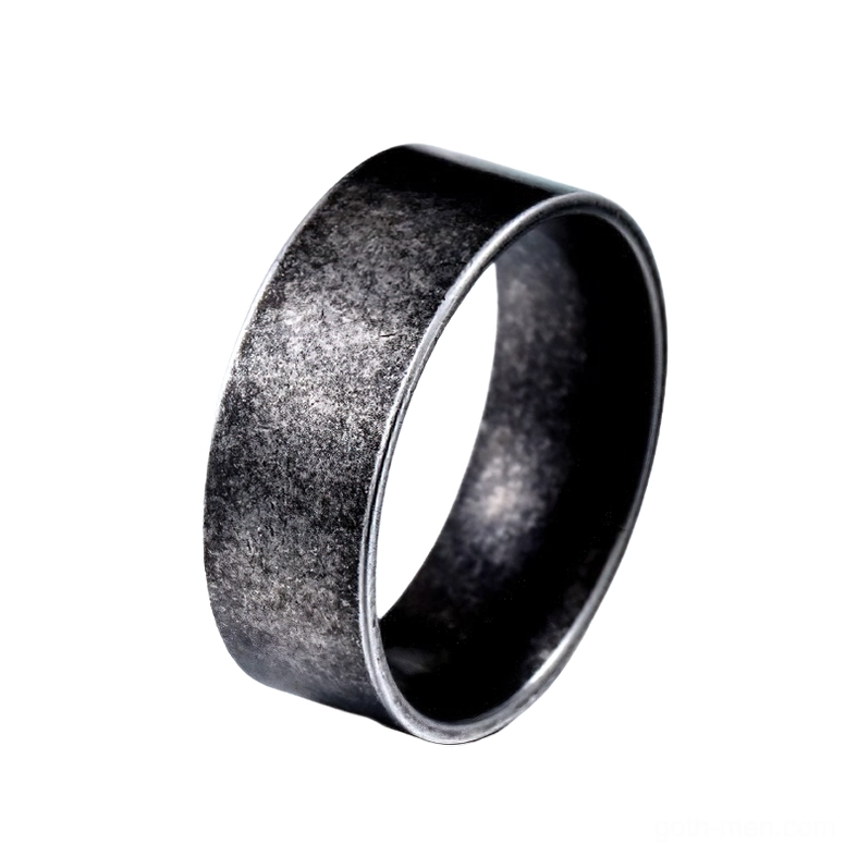 Minimalist gothic stainless steel band ring with matte black finish, three-quarter side view on white background, showing smooth polished surface and vintage metal aesthetic