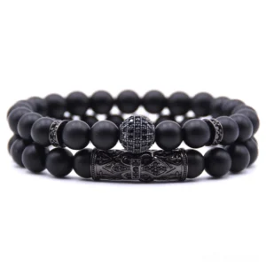 Black gothic dual-strand beaded bracelet with carved ball clasp and black-toned metal hardware, flat lay view