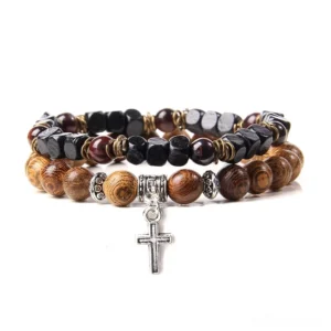 Multicolor gothic bracelet featuring black brown stone beads with silver cross pendant charm, front view flat lay