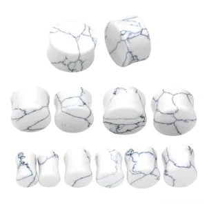 assorted white marble stone ear expander gauges multiple sizes flat lay display gothic jewelry set