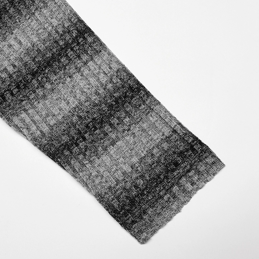 Macro detail of sweater cuff showing gradient gray-black striped ribbed knit texture and fabric composition of gothic sweater