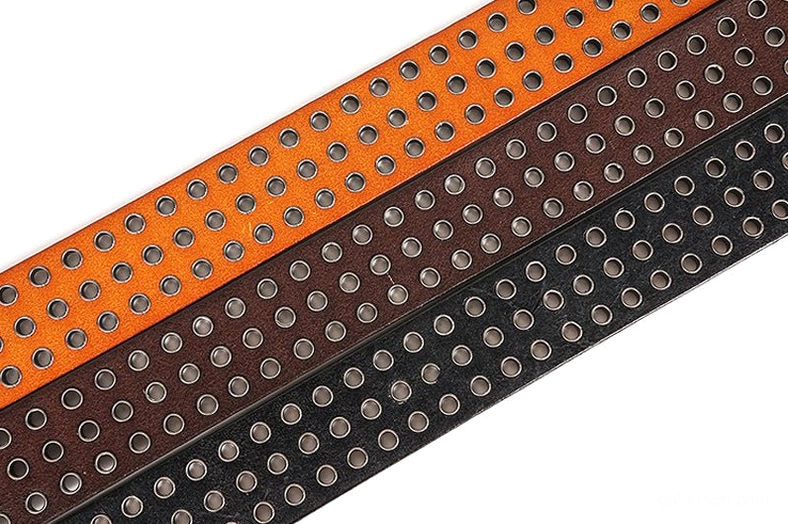 Close-up of perforated leather strap ends with round metal grommets on gothic studded belt three colors