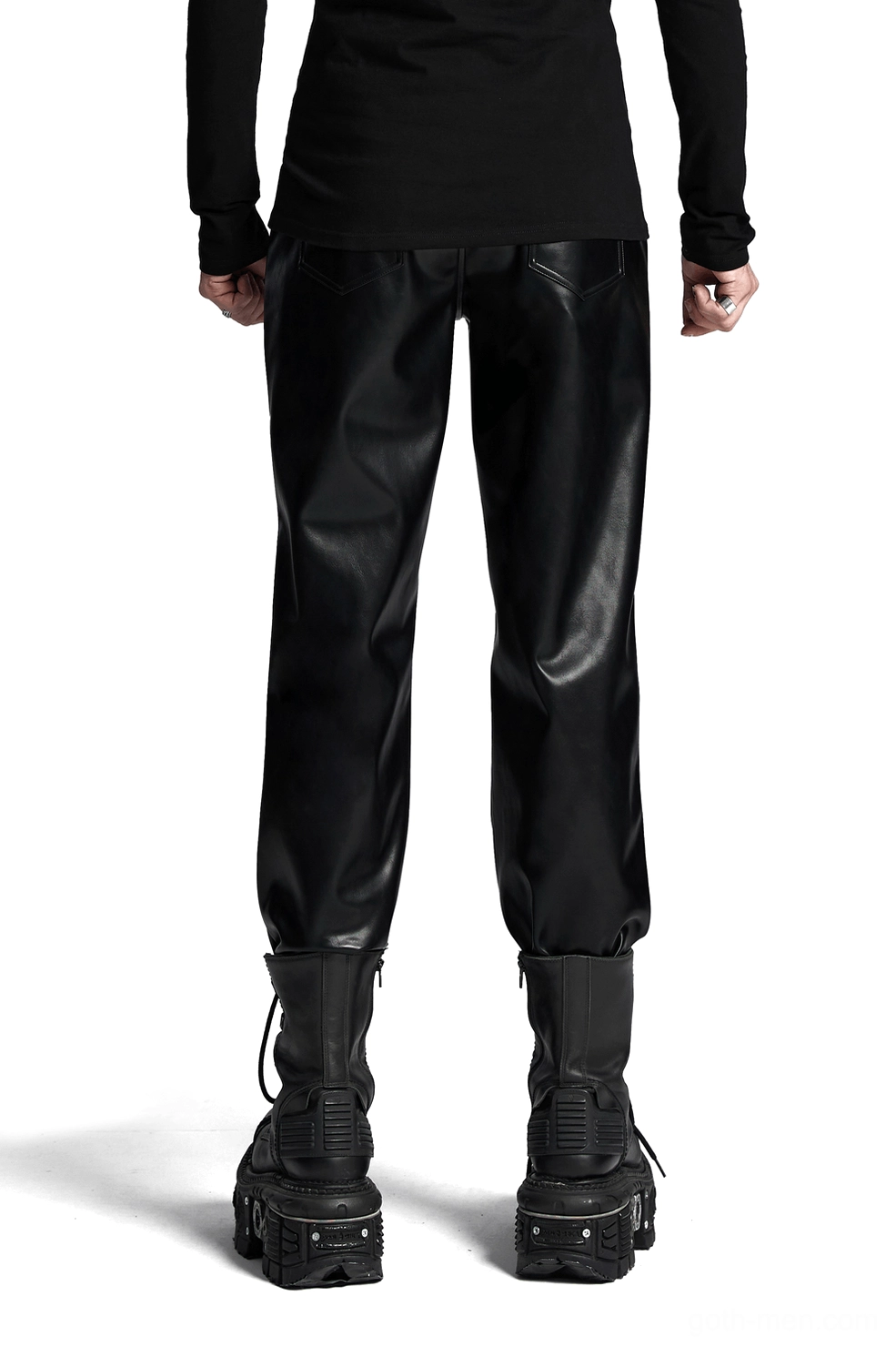 Male model wearing black gothic studded leather pants, back full-body view showcasing slim tapered fit