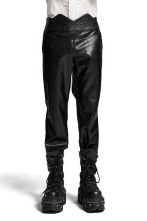Male model wearing black gothic studded faux leather pants with 3D curved waistband, front full-body view, studio lighting