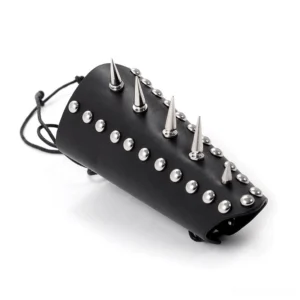 Black studded leather wrist guard with cone spikes and round metal studs, three-quarter angle view showing aggressive spike detailing and lace-up closure system