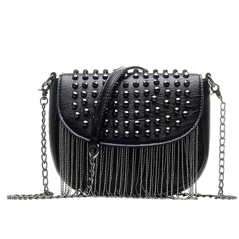 Gothic studded leather shoulder bag worn as crossbody style, three-quarter view displaying chain tassel and rivet embellishments