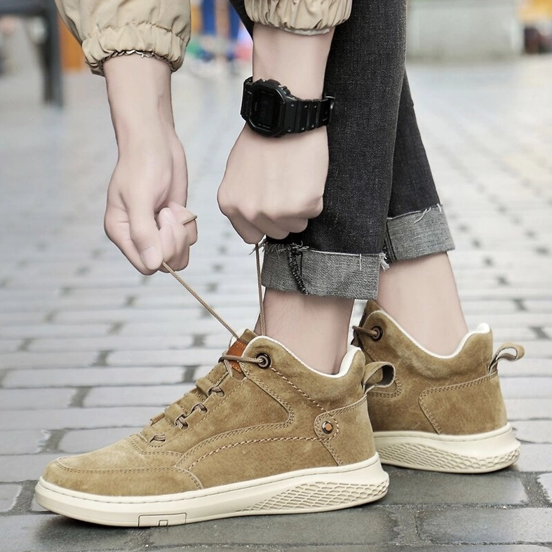 Detailed view of beige suede gothic ankle boots showing upper material quality and design elements