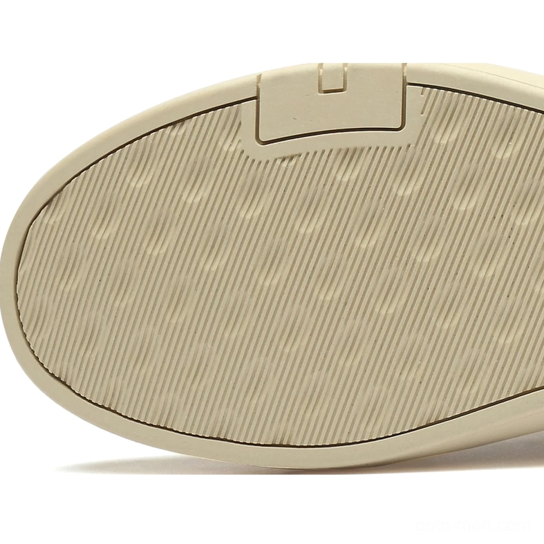Close-up overhead view of gothic suede ankle boot outsole featuring striped rubber tread and reinforced accents