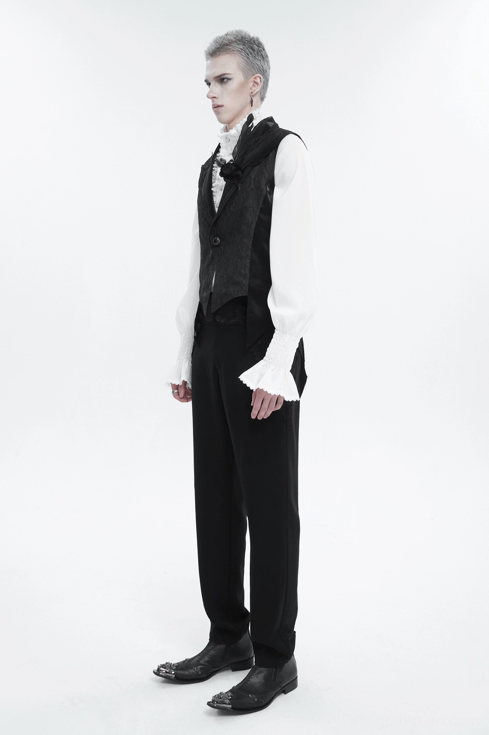 Black gothic swallowtail waistcoat styled with white ruffled gothic shirt and black formal pants on male model