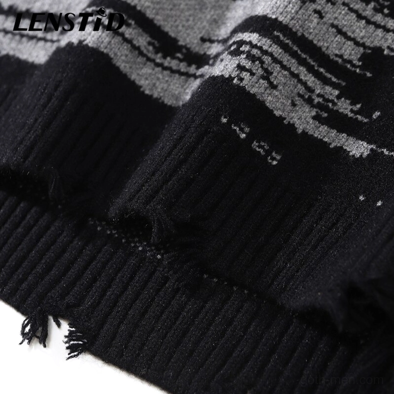 Close-up of distressed hem and frayed edges on gothic oversized sweater showing ribbed knit trim construction