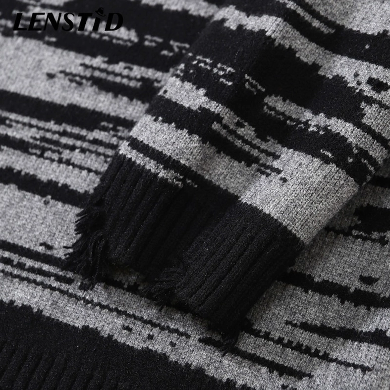 Close-up of gothic sweater sleeve showing frayed cuff, ribbed knit texture, and abstract striped pattern detail