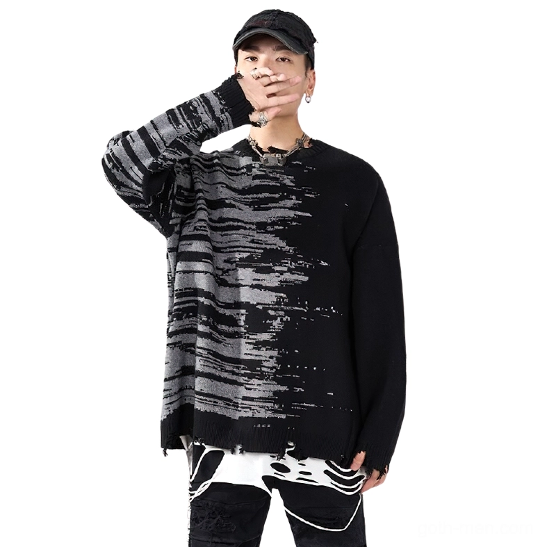 Three-quarter front view of black gothic sweater on model with frayed sleeve cuffs and abstract patchwork design