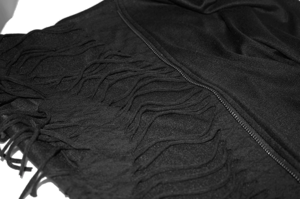 Black gothic sweatshirt tassel fringe texture detail on knit fabric showing woven tassel edging