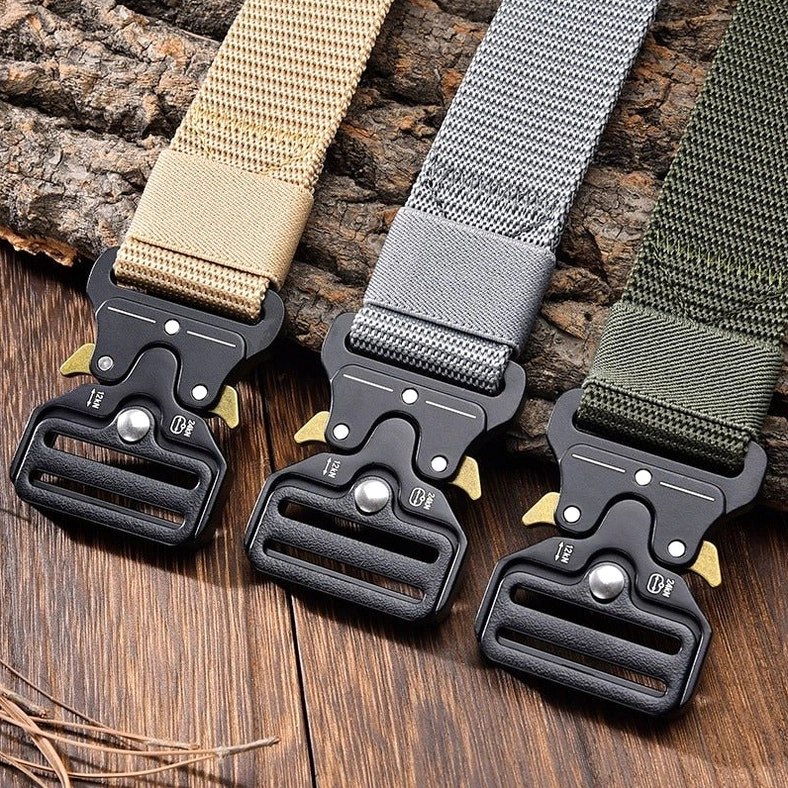 Multiple tactical nylon belts in khaki, gray, and green displayed on natural background