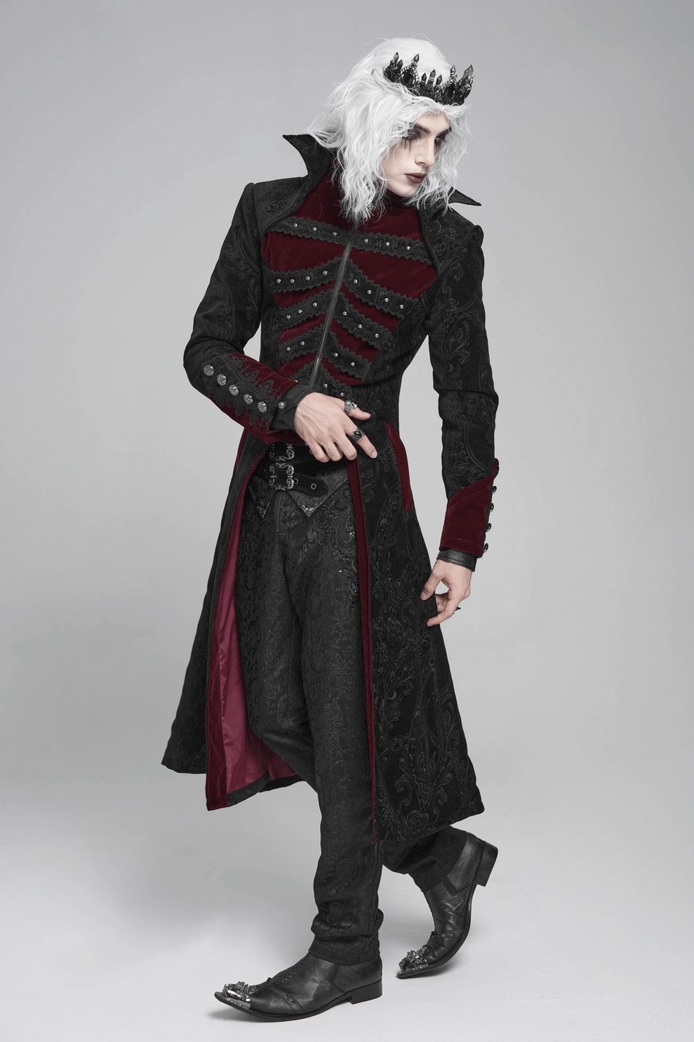 Detail view of gothic tailcoat showcasing embossed brocade fabric pattern and wine red velvet panel integration