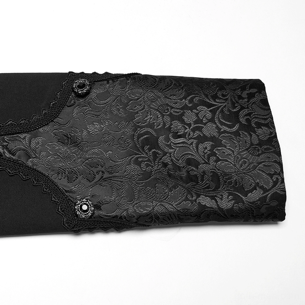 Close-up detail of gothic tailcoat cuff showing floral jacquard texture and decorative button with lace trim