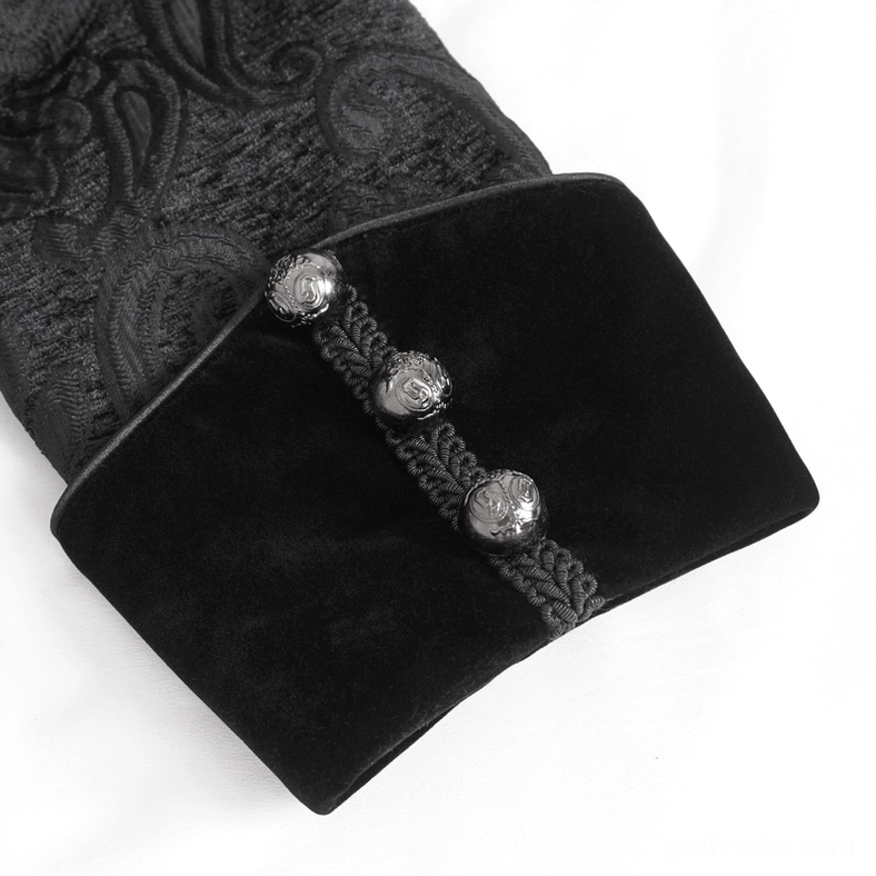 Close-up detail of black velvet cuff with three skull-style metal buttons and braided cord trim