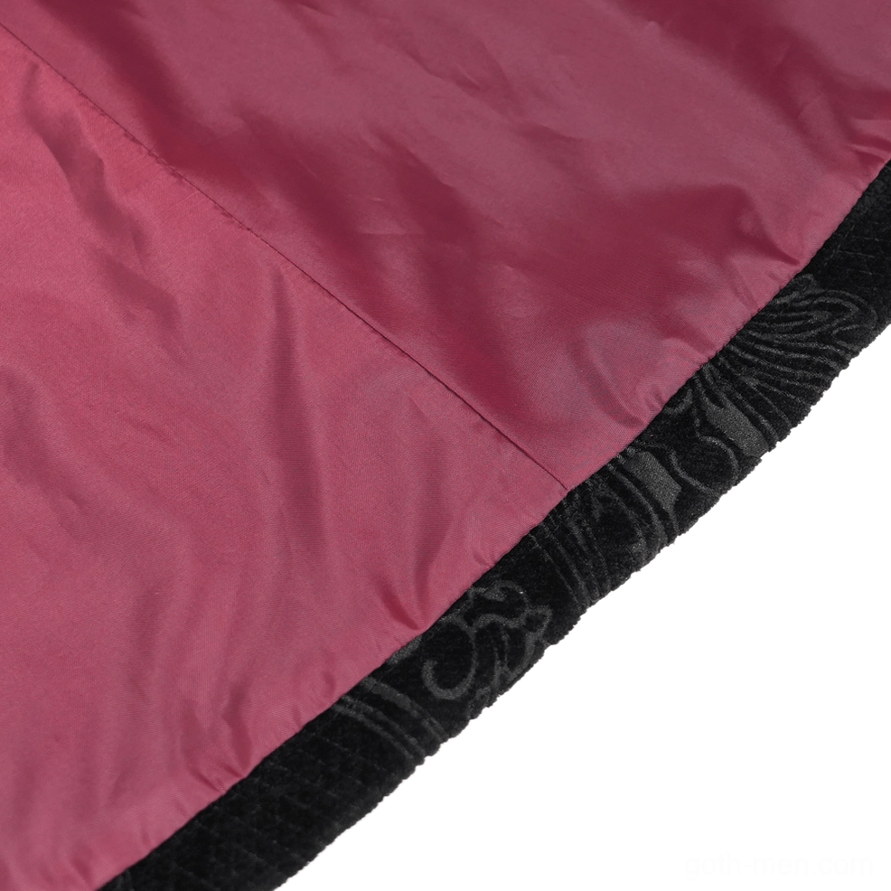 Side detail of gothic tailcoat cuff showing wine red velvet trim, decorative braiding, and fitted sleeve construction