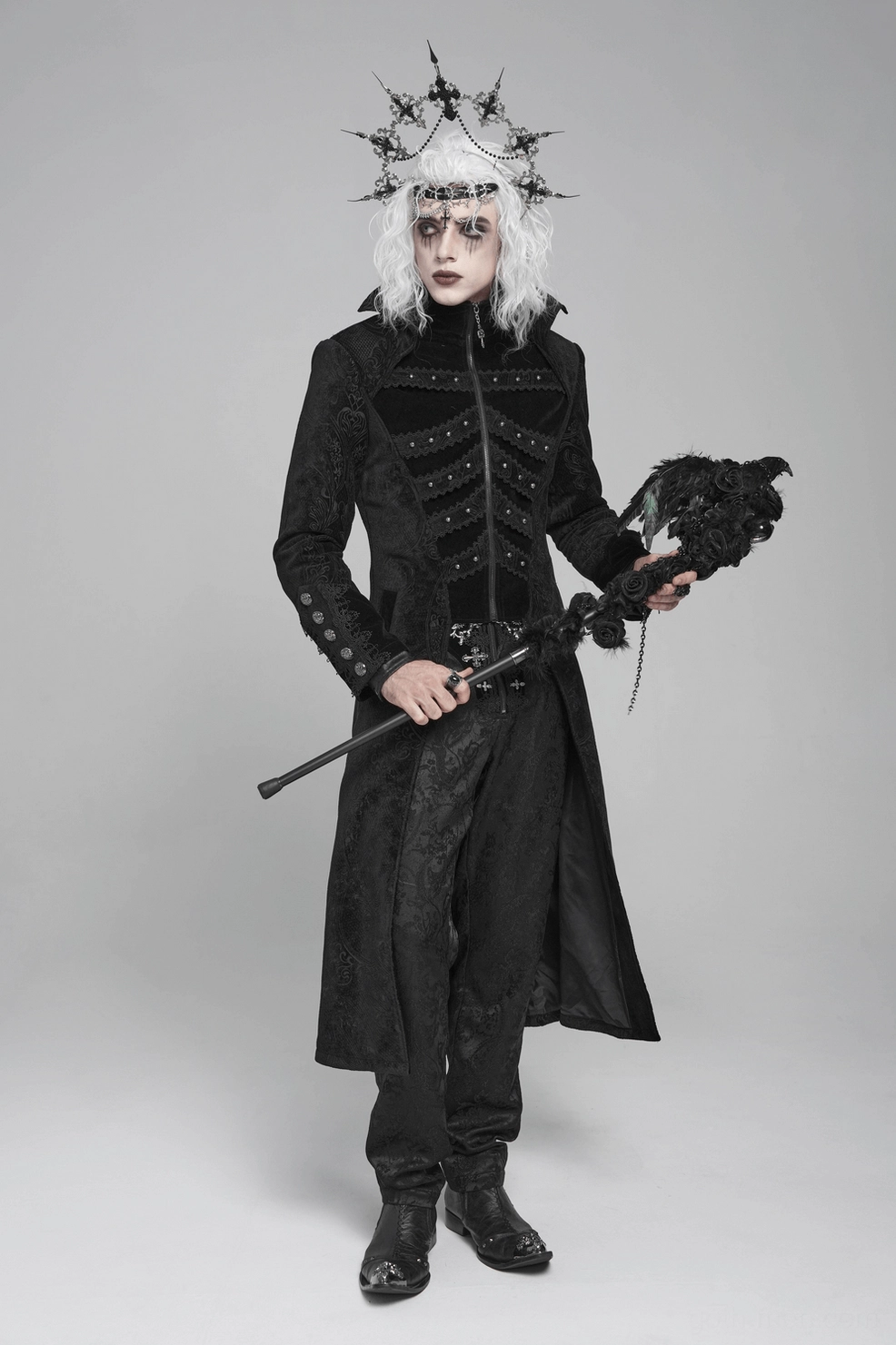 Black Victorian gothic tailcoat front panel detail showing velvet texture, studs, and decorative braiding elements