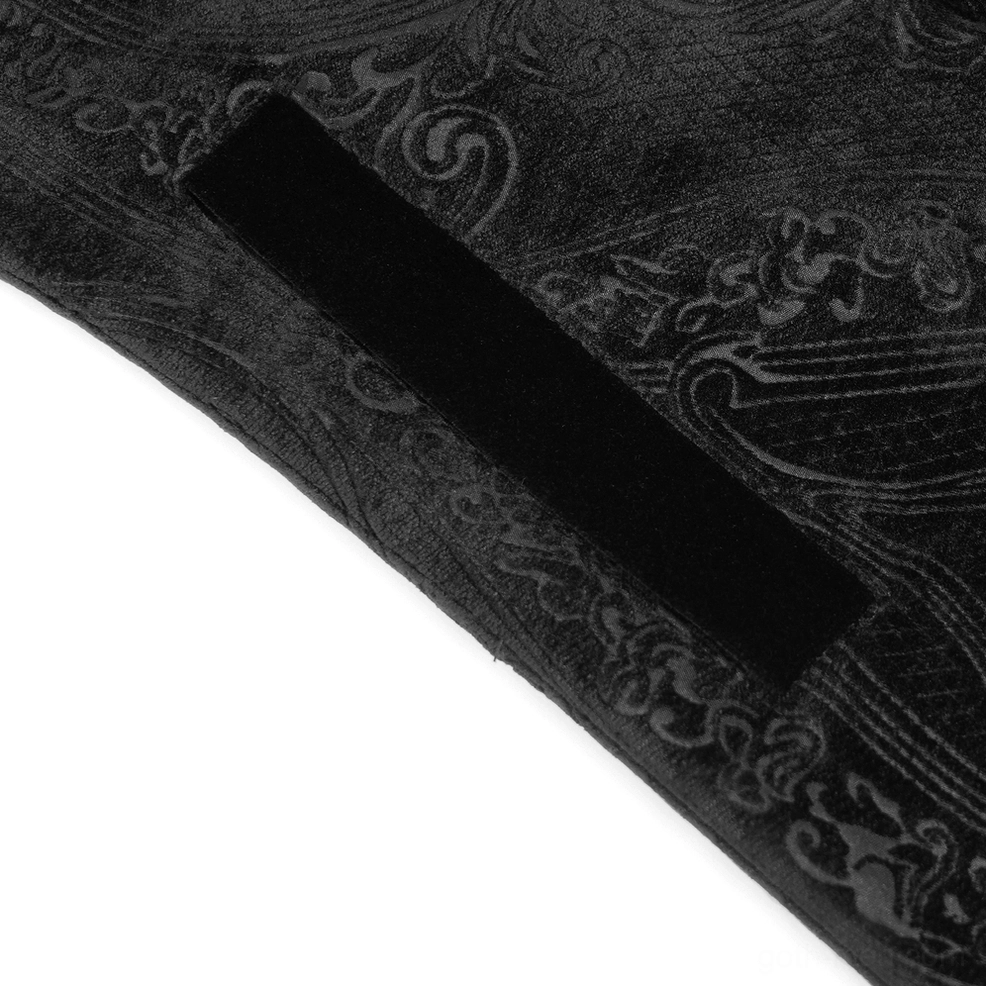 Black gothic tailcoat hem and skirt detail showing extended dramatic cut and brocade pattern on lower garment section