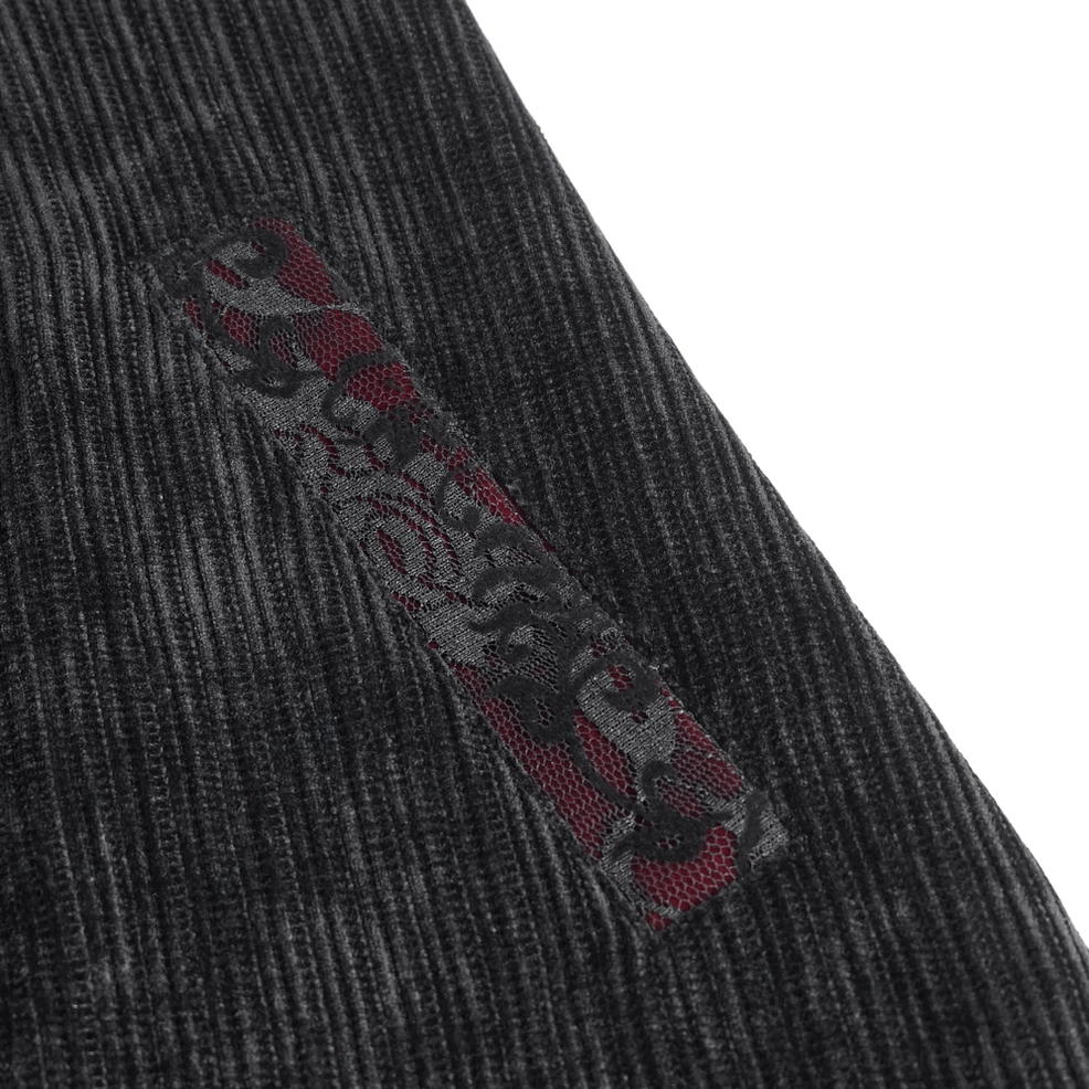 Gothic black velvet tailcoat showing precision tailoring and embroidered front panel details