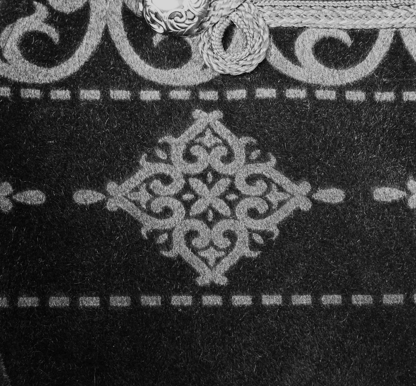 Black gothic velvet tailcoat showing constructed shoulder architecture and button arrangement detail