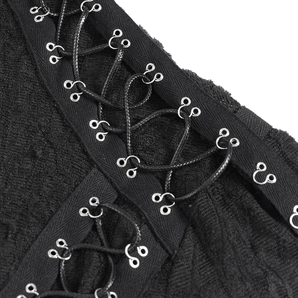 Macro detail of gothic tank's woven lace trim and textured cracked mesh fabric