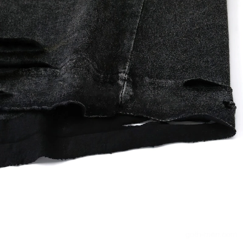 Bottom hem close-up showing frayed distressed ripped edge on black cotton fabric