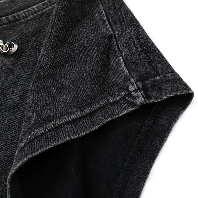 Shoulder and armhole detail showing small metal eyelet and raw sleeveless edge construction