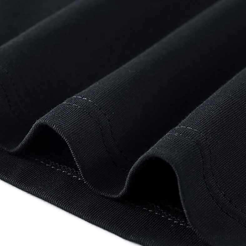 Double-stitched seam and hem detail on gothic tactical patchwork tee showing construction quality