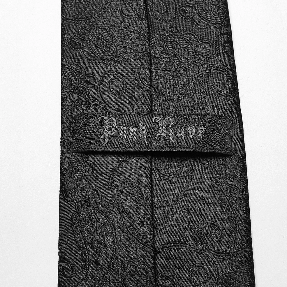 Gothic necktie inner lining detail showing punk rave embroidery and paisley jacquard fabric construction on black tie