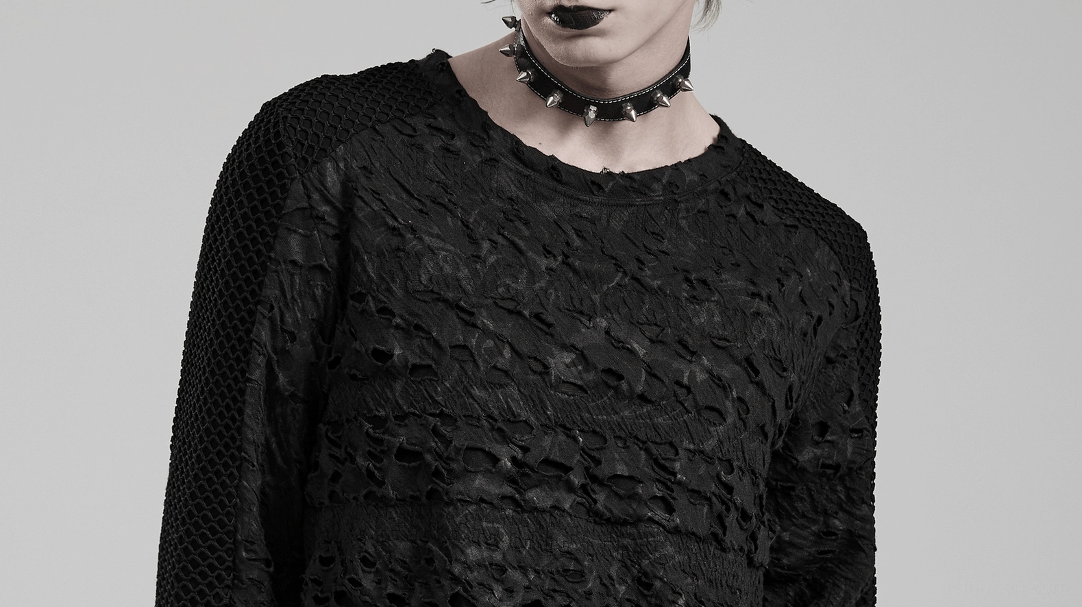 Close-up front view of gothic men's mesh top showing spiked choker styling and distressed fabric detail on male model