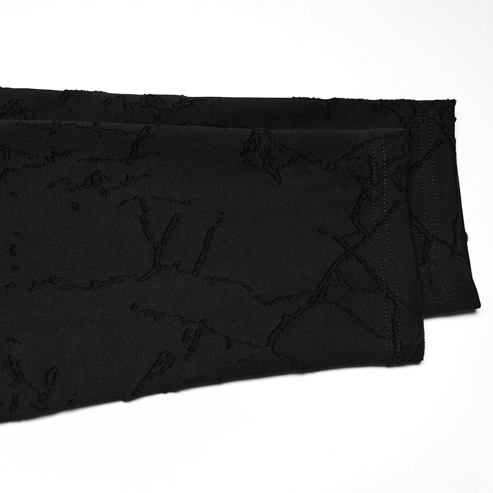 Black gothic top garment panel close-up flat lay, cracked textured fabric, folded garment section showing distressed detail