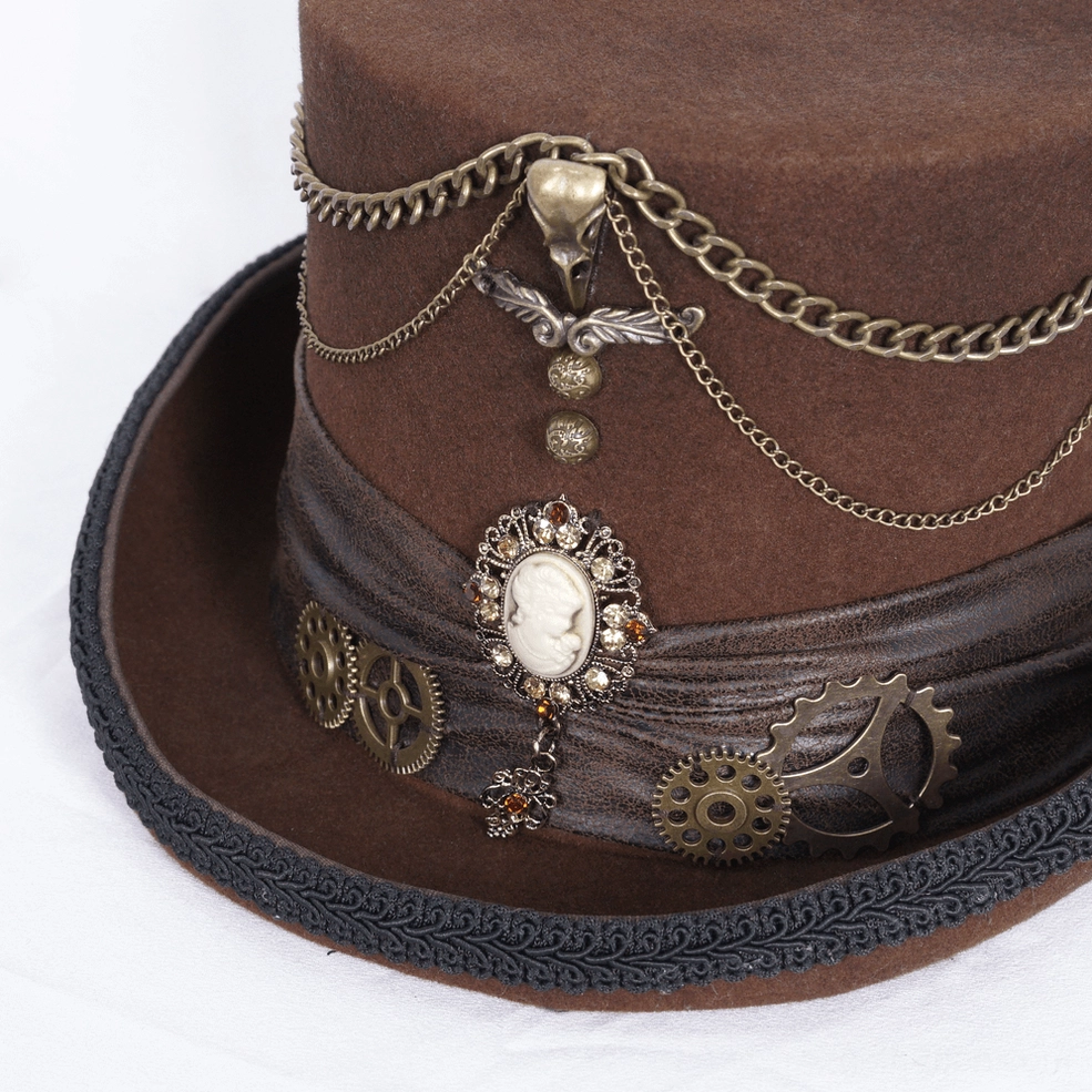 Close-up detail of gothic steampunk top hat crown showing embossed chain trim, cameo brooch, and metal gear ornaments