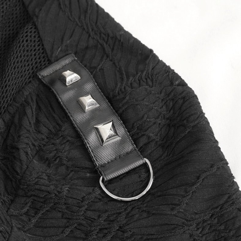 Close-up of pyramid rivets and metal ring accents on shoulder strap of black gothic top