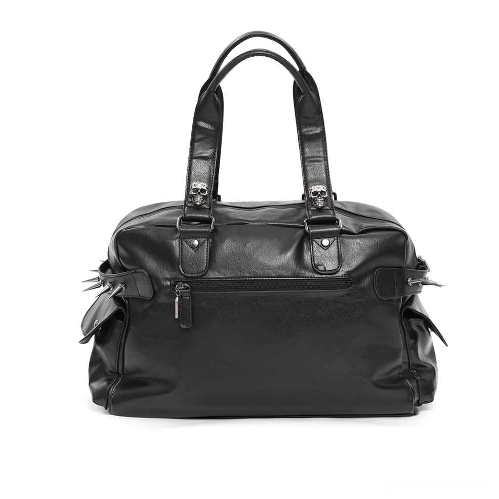 Black gothic tote bag front flat lay displaying plain leather surface, front zipper pocket, and decorative spike side accents
