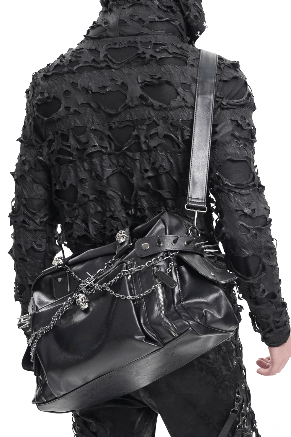 Male goth style model carrying black chain embellished gothic tote bag crossbody, back view showing strap adjustment
