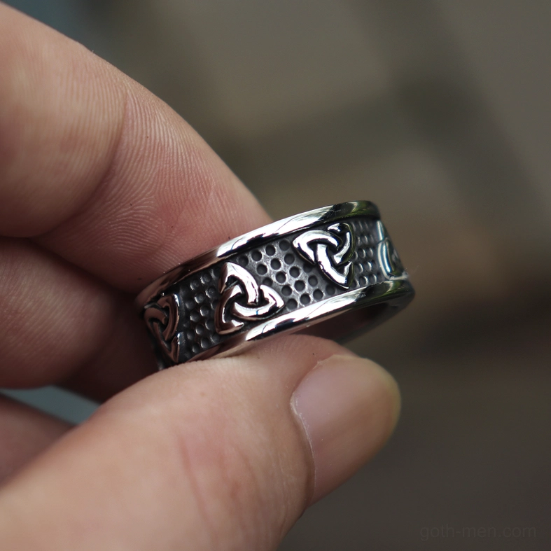 Gothic Celtic knot ring worn on human fingers eye-level holding perspective
