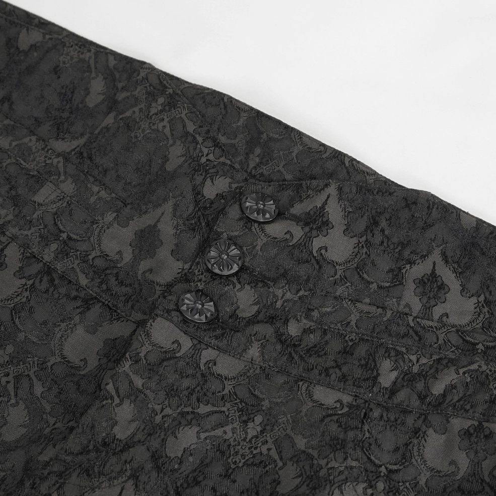 Close-up detail of black damask jacquard fabric texture and branded decorative buttons gothic trousers
