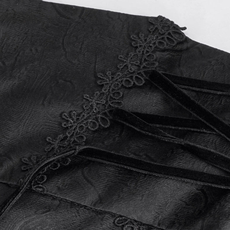 Velvet lace-up trim detail on gothic trousers with embroidered floral embellishment